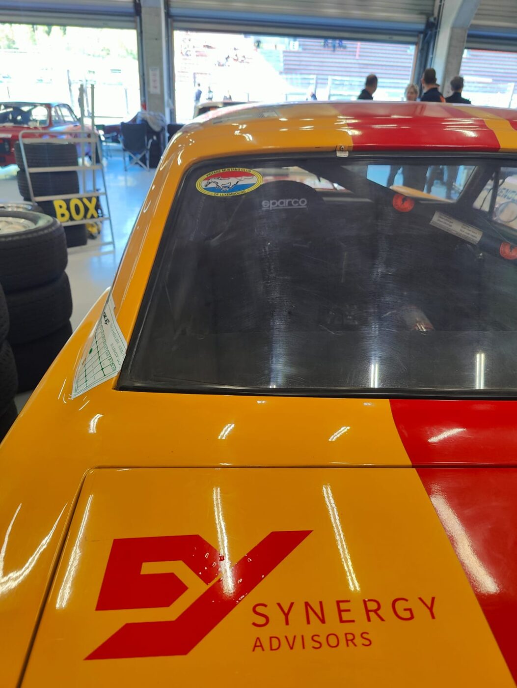Synergy Advisors logo on the sponsored Mustang